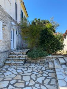 a stone walkway in front of a building at Дом для дружной семьи in Mikros Gialos