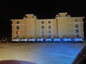 a large building with cars parked in a parking lot at Lüx daire in Pelitli