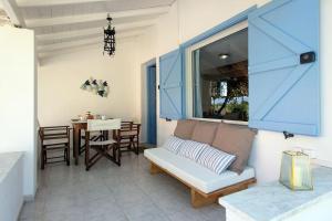 a living room with a couch and a table at Sea Breeze Coastal House in Almyros Beach in Almiros Beach