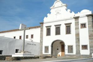 a white building with a clock tower on top at Convento da Orada - Monsaraz in Monsaraz