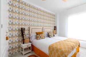 a bedroom with a large bed and a wall at Genteel Home Victoria in Cádiz
