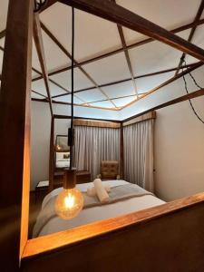 a bedroom with a canopy bed with a light on it at Seaview Family Cottage in Swakopmund