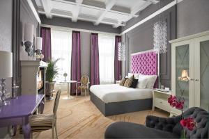a bedroom with a bed and a living room at Aria Hotel Budapest by Library Hotel Collection in Budapest