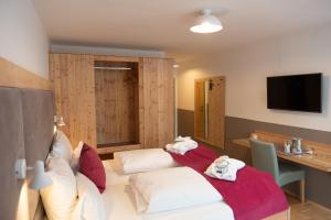 Zimmer mit 2 Betten, einem Tisch und einem TV in der Unterkunft Santner, Hotel in Eugendorf