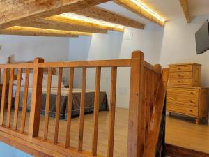a bedroom with a bed and a wooden staircase at La Cabañita in Tejeda