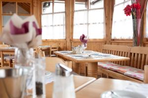 a dining room with tables and chairs and windows at Santner, Hotel in Eugendorf