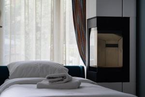 a bedroom with a bed with towels on it at Edem Luxury Apartments in Nea Peramos