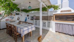a kitchen with a table and chairs and a kitchen with aorus at Giourgas Studios & Apartments in Provatas