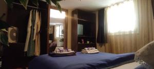 a bedroom with a blue bed with towels on it at SHLEY House 1 in Artemida