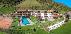 an aerial view of a resort with a swimming pool at Hotel Sonnenalm in Saltusio