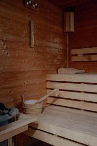 a sauna with a bucket in a wooden room at Arkánum Hotel in Balatonmáriafürdő +25 photos