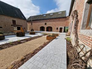 a courtyard of a building with a brick building at Gîte Eschen in Plombières