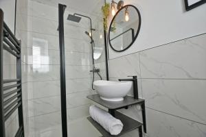 a bathroom with a sink and a mirror at Quirky cottage set in Clitheroe in Clitheroe
