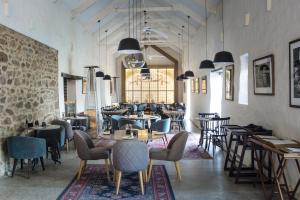 a restaurant with tables and chairs in a room at The Homestead at Hazendal, in Stellenbosch Winelands by NEWMARK in Stellenbosch