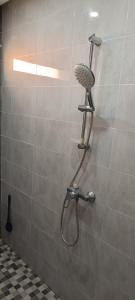 a shower with a shower head in a bathroom at Dar Lebharr Studio in Kelibia