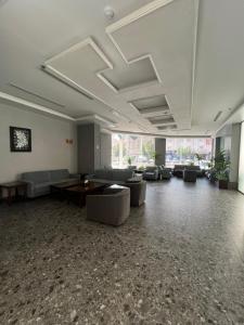 a large living room with couches and tables at W Platinum Hotel in Medina