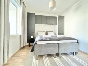 um quarto com uma cama e uma grande janela em Tammer Huoneistot - City Suite 5 - Own Sauna, Balcony & Best Location em Tampere