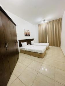 Postel nebo postele na pokoji v ubytování Husin Al Khaleej Hotel Apartment