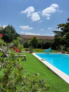 una piscina en un patio con césped verde en Suite à la Villa Cattus, en Bram