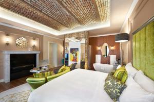 a hotel room with a bed and a fireplace at Aria Hotel Budapest by Library Hotel Collection in Budapest