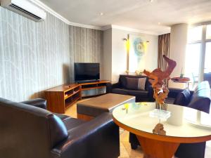 a living room with a couch and a table at 603 Oyster Rock Umhlanga Rocks in Durban