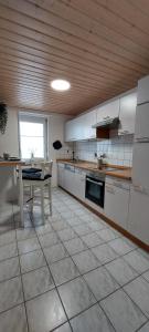 una cocina con mesa y un tablero asterisco en Gemütliche Ferienwohnung am Schwarzwaldrand, en Jettingen