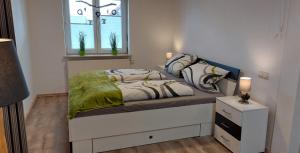 a bedroom with a bed and a window at Gemütliche Ferienwohnung am Schwarzwaldrand in Jettingen