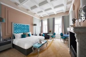 a hotel room with a bed and a table and chairs at Aria Hotel Budapest by Library Hotel Collection in Budapest
