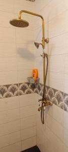 a shower with a shower head in a bathroom at Dar Lebharr Kélibia in Kelibia