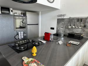 a kitchen with a counter with a stove top oven at Sanduli Luxury House in Agrigento
