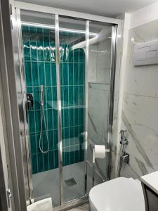a bathroom with a shower and a toilet at Sanduli Luxury House in Agrigento +15 photos