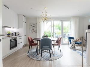 a kitchen and dining room with a table and chairs at Villa Baltic Zingst - AP Strandfein in Zingst