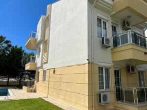 a large apartment building with balconies and a yard at SunSet Apartments 4,5,6 in Belek