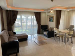 a living room with a couch and a table at SunSet Apartments 4,5,6 in Belek