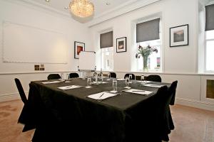 a meeting room with a table with black table cloth at The Rathbone Hotel, Fitzrovia in London +15 photos