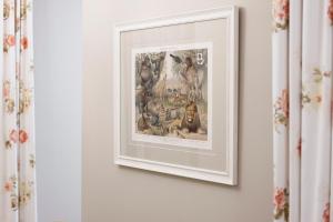 a framed picture of animals on a wall at Gatto Perso Luxury Studio Apartments in Thessaloniki