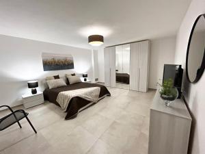 a bedroom with a bed and a television in it at Domus Alba Apartment in Trapani