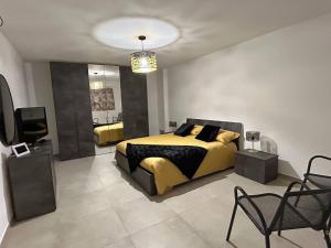 a bedroom with a bed and a tv in it at Domus Alba Apartment in Trapani
