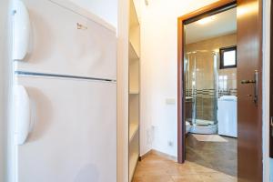 a bathroom with a refrigerator and a toilet at Apartments Svetlana in Tivat