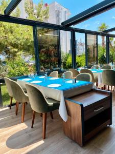 a dining room with a table and chairs at Zeynel Hotel in Antalya
