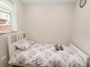 ブリドリントンにあるFrankies Seaview 2の寝室に靴が置かれた白いベッド