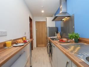 a kitchen with a counter with plates of food on it at Frankies Seaview 4 in Bridlington +9 photos