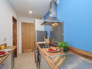 a kitchen with a counter with a plate of food at Frankies Seaview 4 in Bridlington