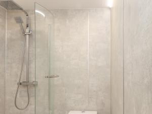 a bathroom with a glass shower with a toilet at Frankies Seaview 4 in Bridlington
