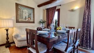 a dining room with a wooden table with chairs and a dining room at City Apartments Salute-Accademia in Venice