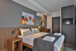 a bedroom with a bed and a tv on the wall at Wolf Of The City Hotel & Spa in Antalya