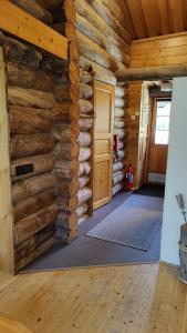 a room in a log cabin with a wooden wall at Kelokallas 2 Ruka in Ruka