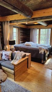 a bedroom with two beds and a couch at Kelokallas 2 Ruka in Ruka