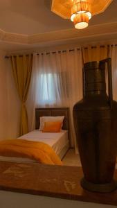 a bedroom with a bed and a vase on a table at Mog'appart in Essaouira