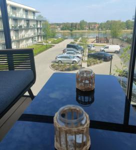 a table with two baskets on top of it with a parking lot at Bridge Apartment & Spa in Dziwnów